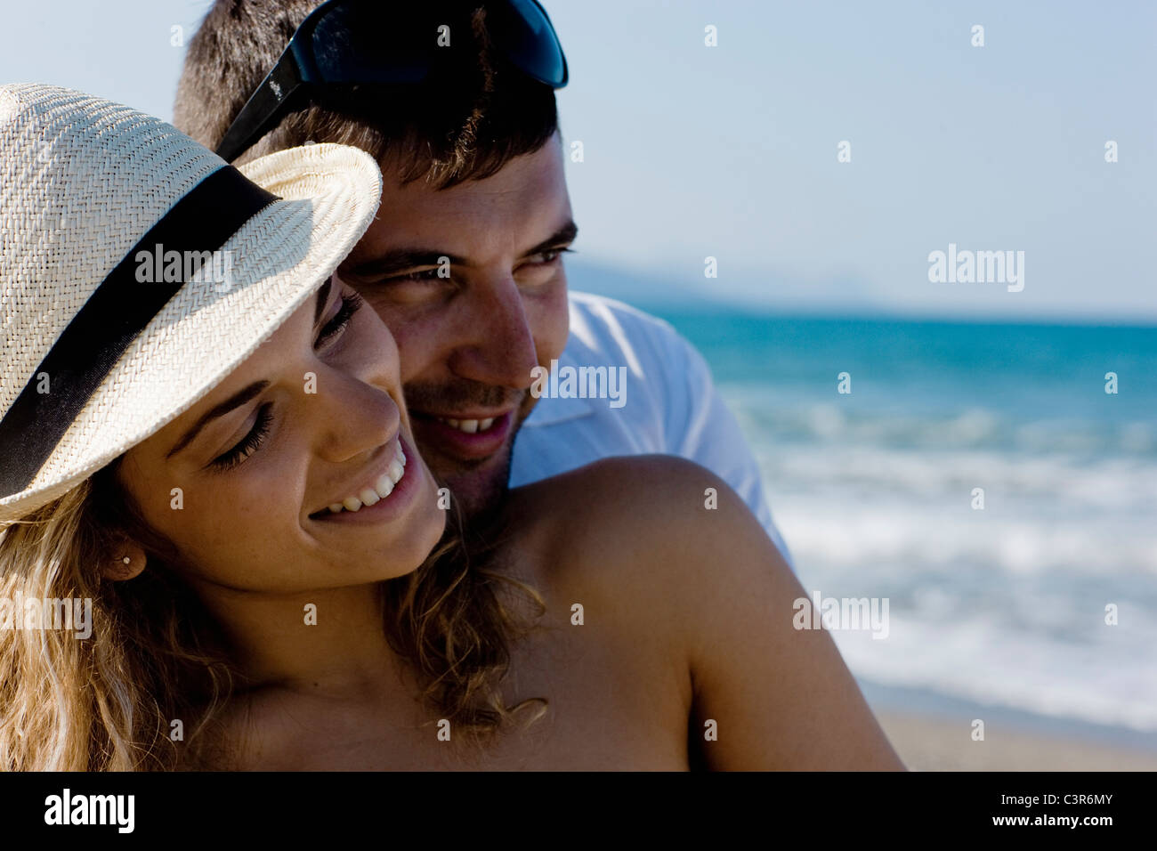 couple on the beach cuddling Stock Photo - Alamy