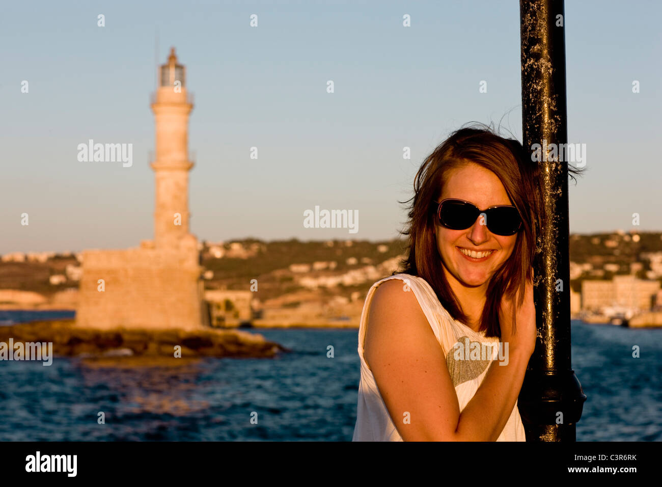 woman smiling at the camera in front of harbour Stock Photo - Alamy
