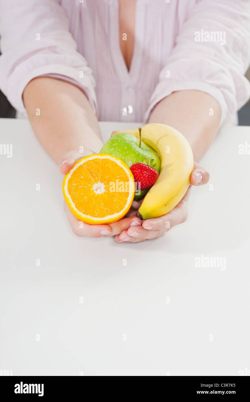 Germany, Cologne, Human hand holding fruits Stock Photo