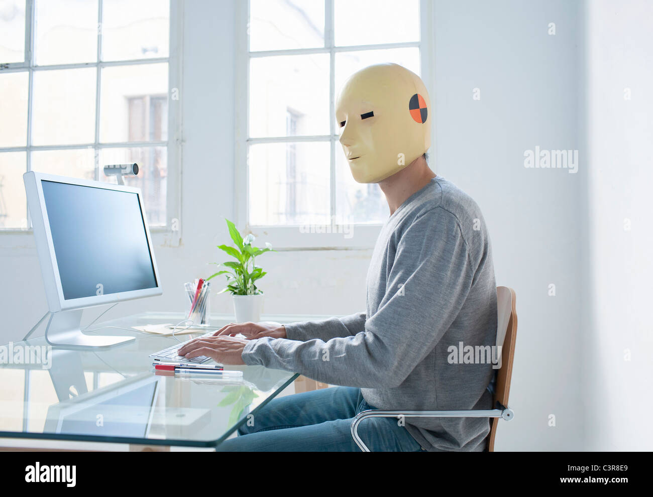 Man in crash test dummy mask in an office Stock Photo - Alamy
