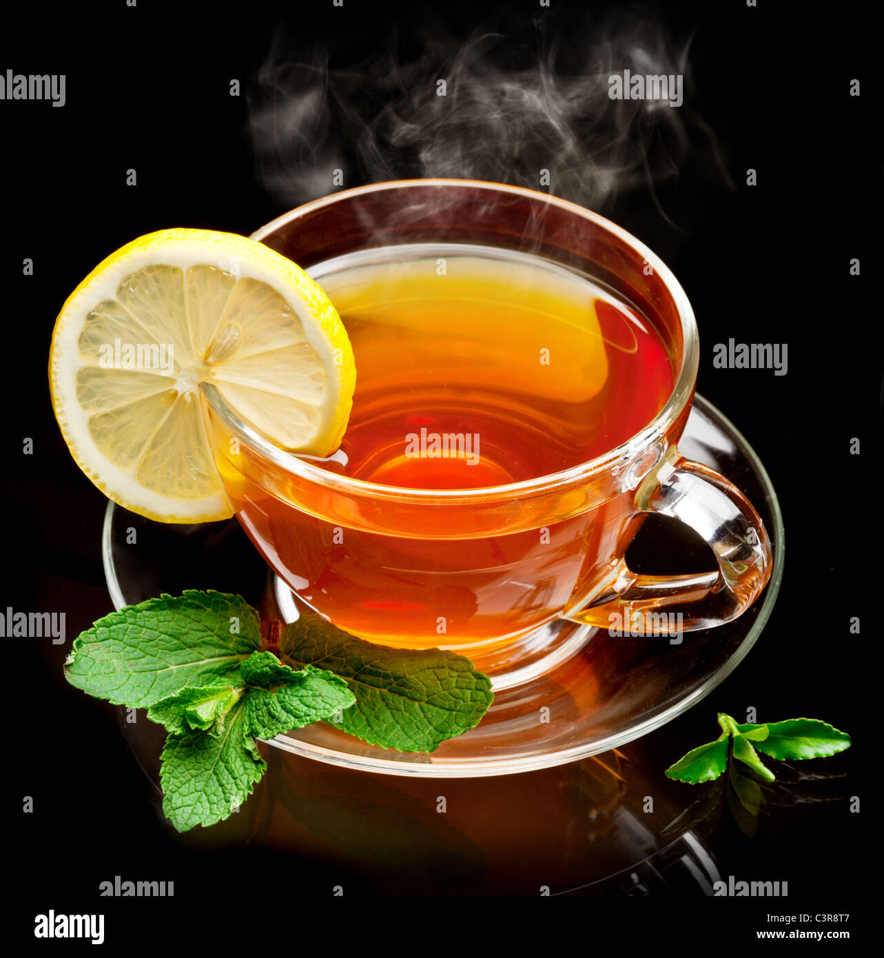 Cup tea with mint and lemon isolated on a black background. Stock Photo