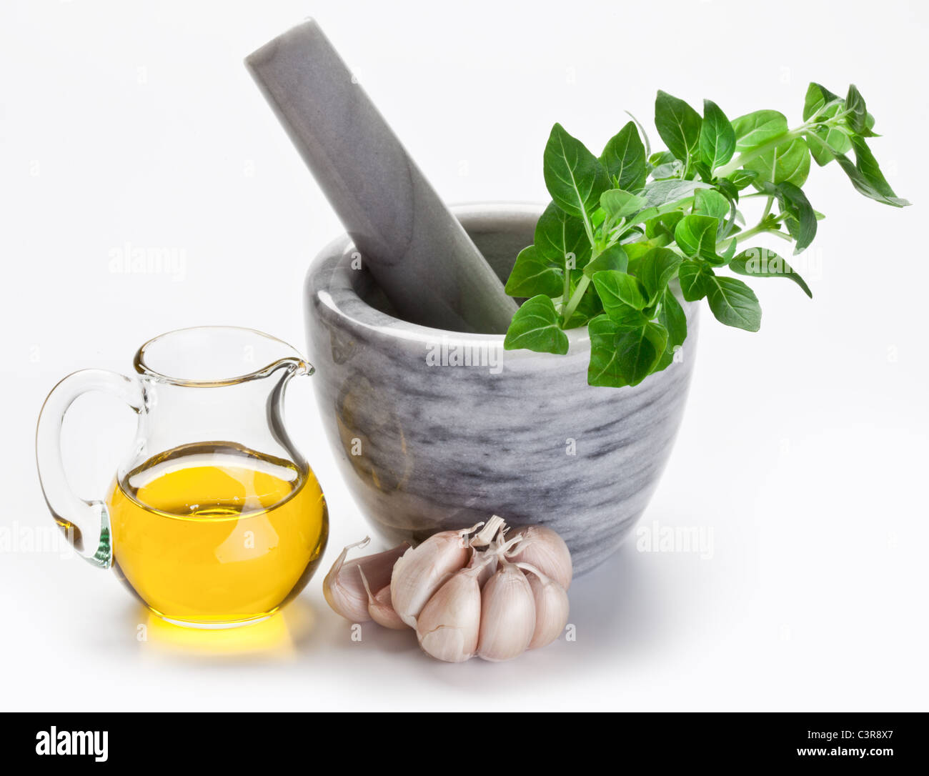 Mortar with pestle and basil herbs and olive oil. Stock Photo