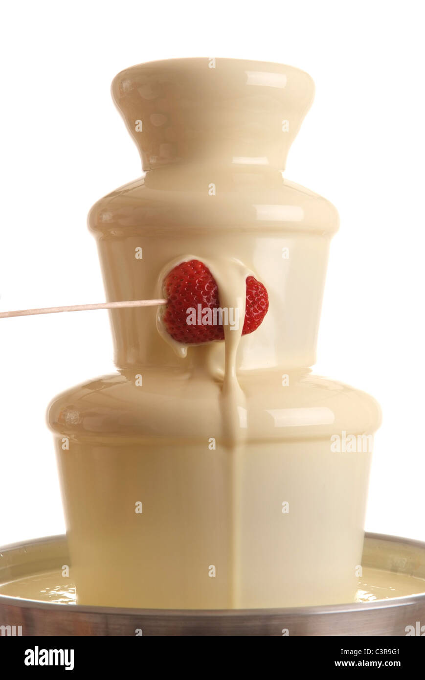 white chocolate fountain with strawberry dipped Stock Photo