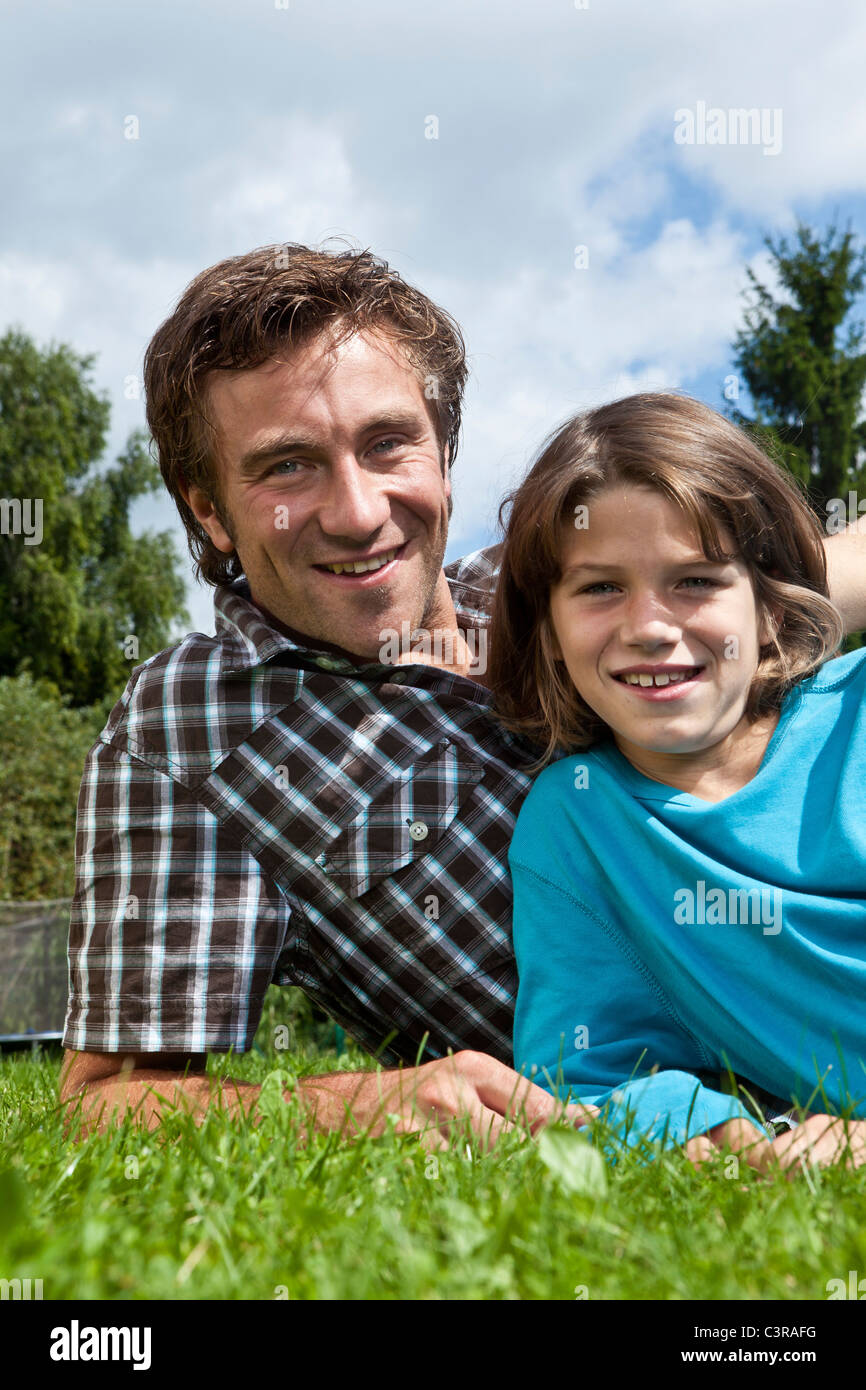 Germany, Munich, Father and son (10-11 Years) in garden, smiling, portrait Stock Photo