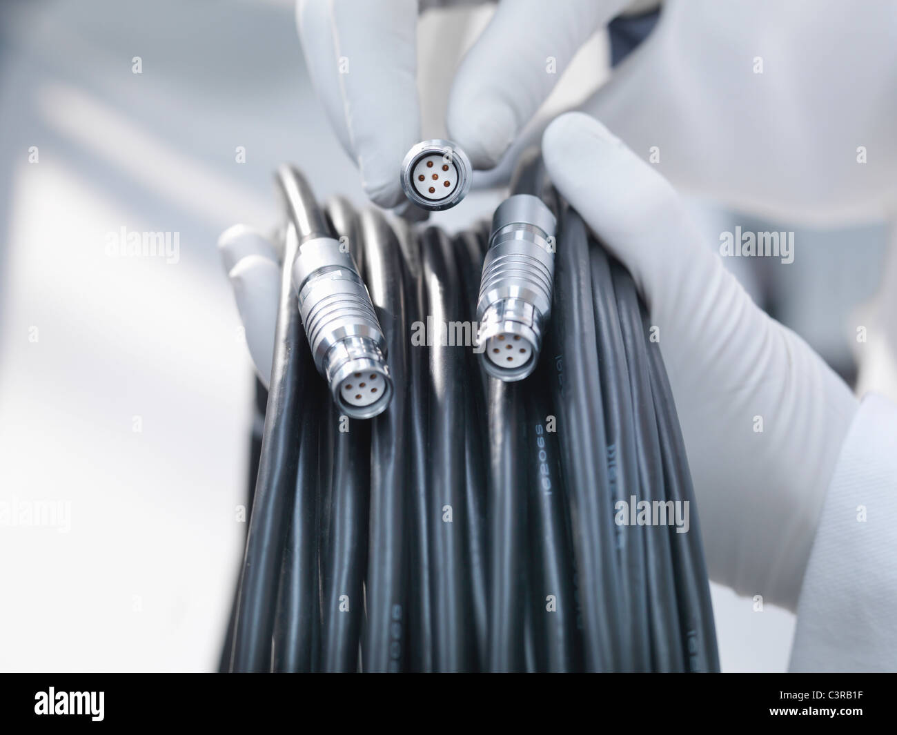 Hands holding cables and cable ends Stock Photo Alamy