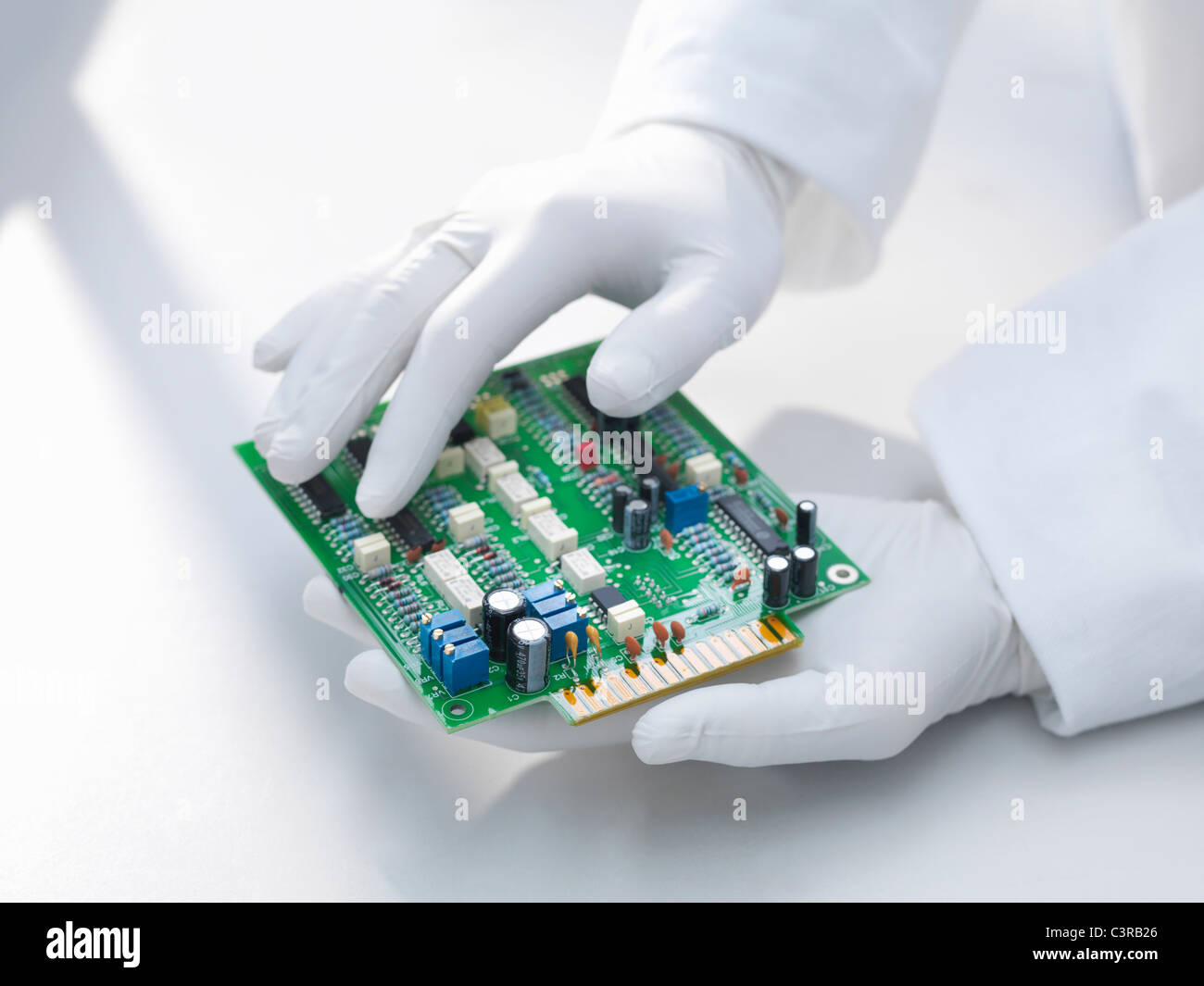 Hands holding circuit board Stock Photo