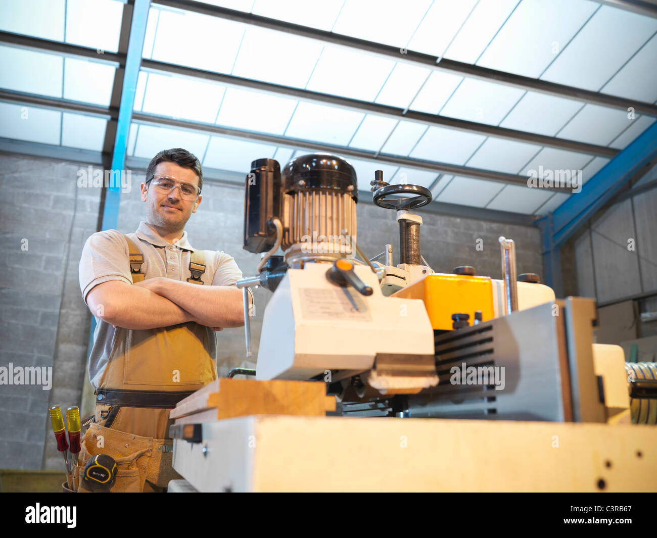 Woodworker with woodwork machine Stock Photo