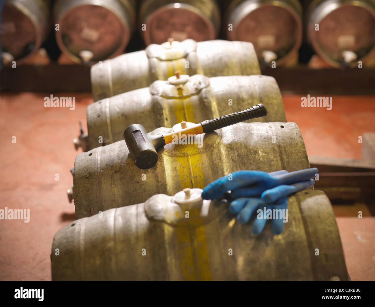 Barrels and hammer in brewery Stock Photo
