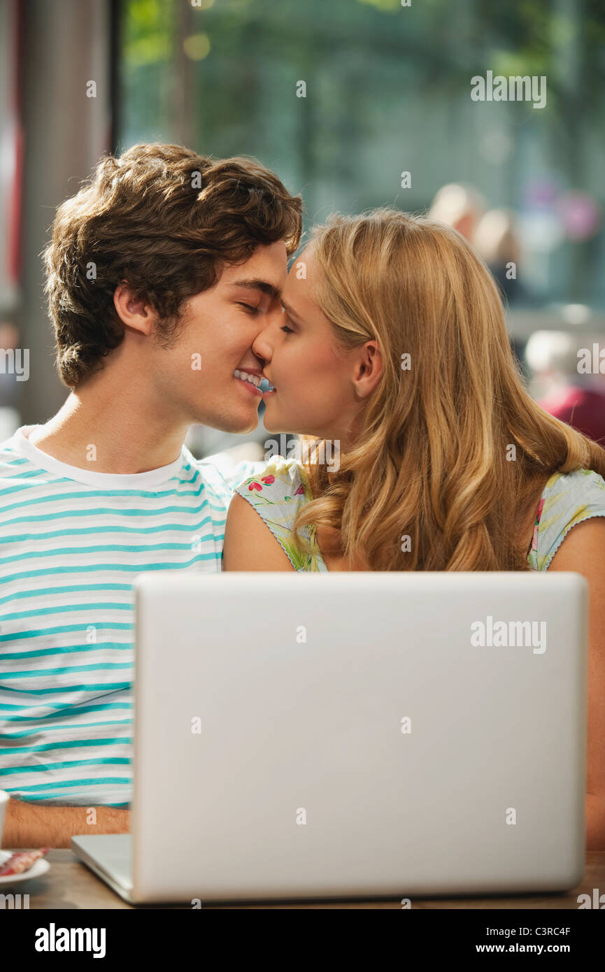 Germany, Munich, Couple kissing in cafe Stock Photo Alamy