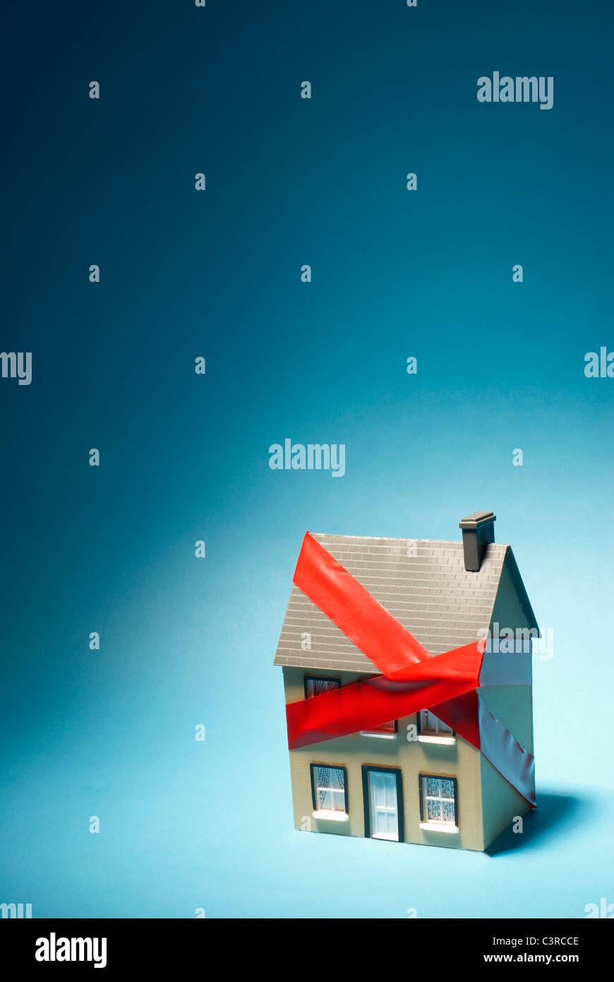 Model house with red tape around it Stock Photo