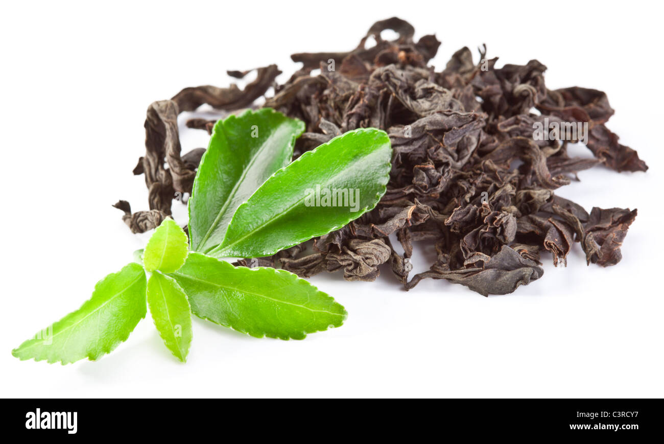 Heap of dry tea with green tea leaves isolated on a white background. Stock Photo