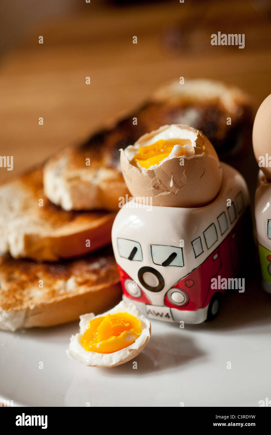 Breakfast - two boiled eggs in VW Camper van egg cups with toast Stock Photo