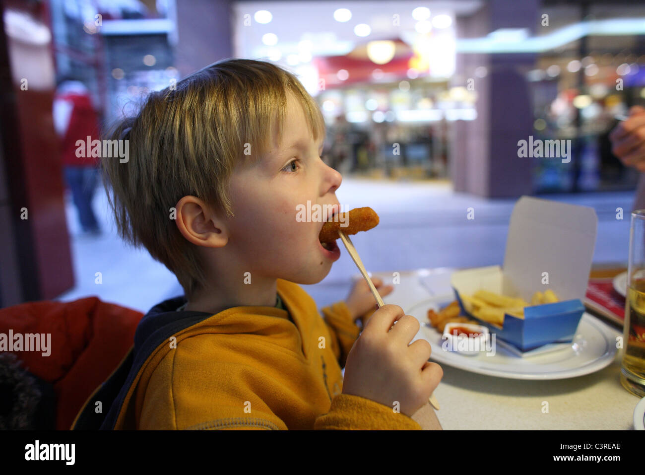 A child eating in a fast food restaurant Stock Photo