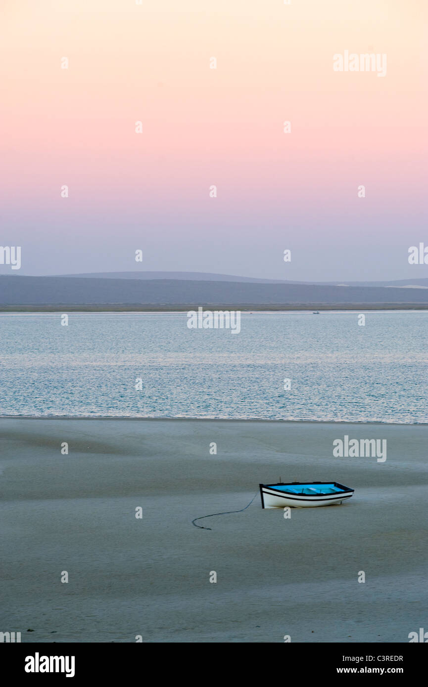 Fishing boat at low tide at dawn, Langebaan lagoon at Churchhaven in West Coast National Park South Africa Stock Photo