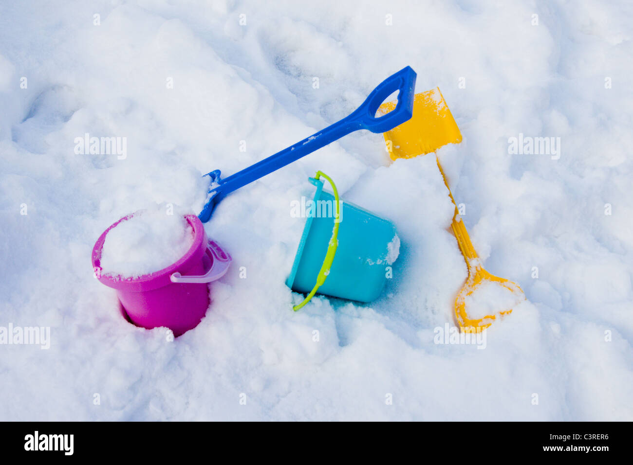Having fun with buckets and spades in snow Stock Photo Alamy