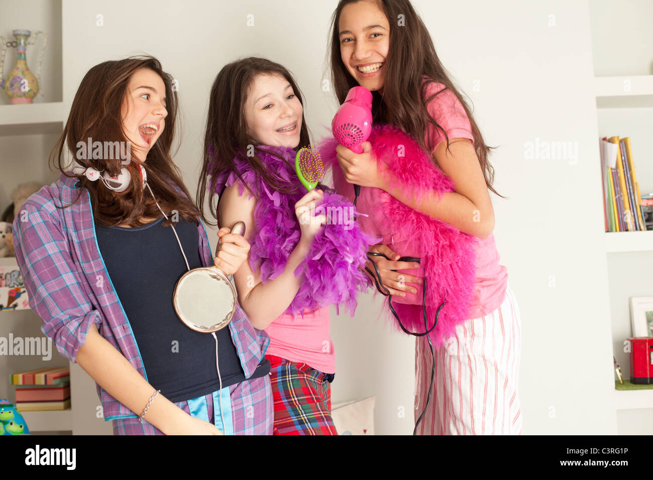 teenage girls singing , wearing pajamas Stock Photo