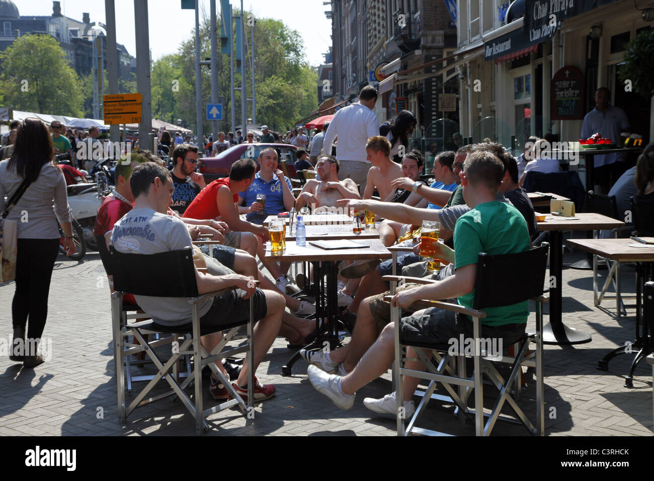 PEOPLE DRINKING OUTSIDE CAFE MONNIKENSTRAAT AMSTERDAM 23 April 2011 Stock Photo
