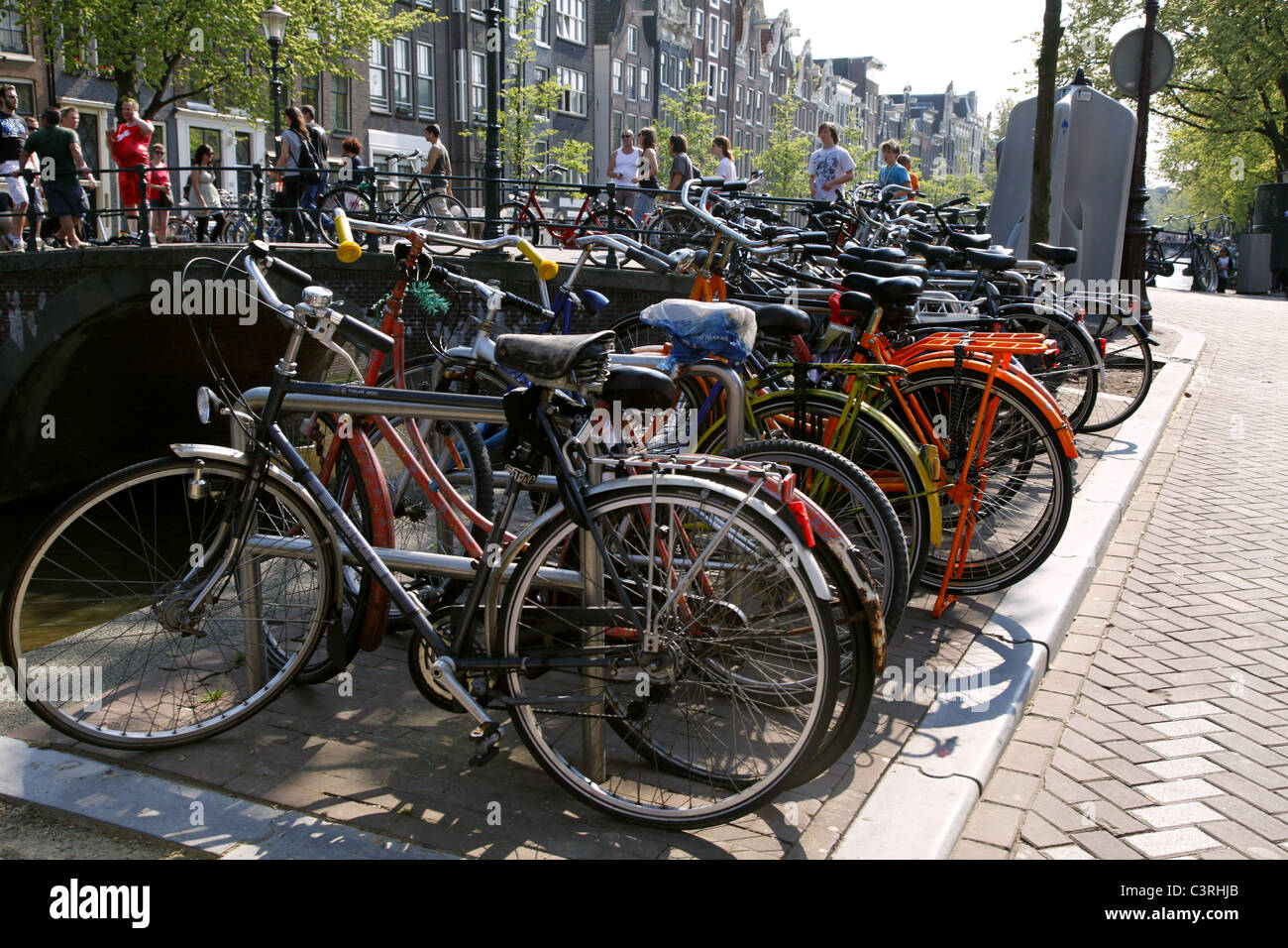 BICYCLES ON CANAL BANK AMSTERDAM HOLLAND 23 April 2011 Stock Photo