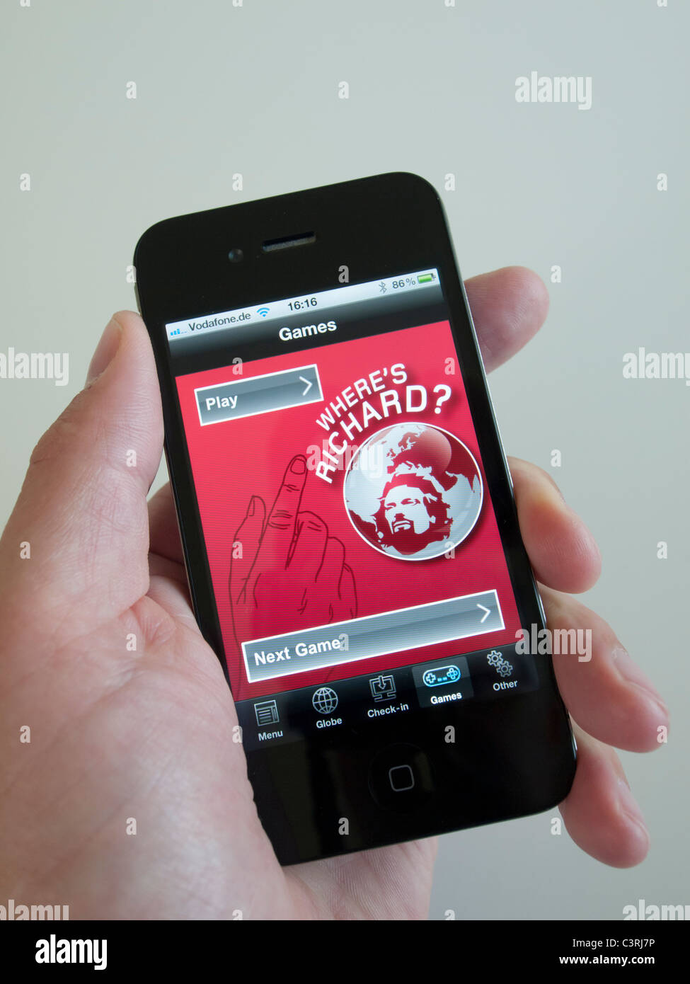 Playing game on Virgin airline app on an iPhone 4G smart phone Stock Photo