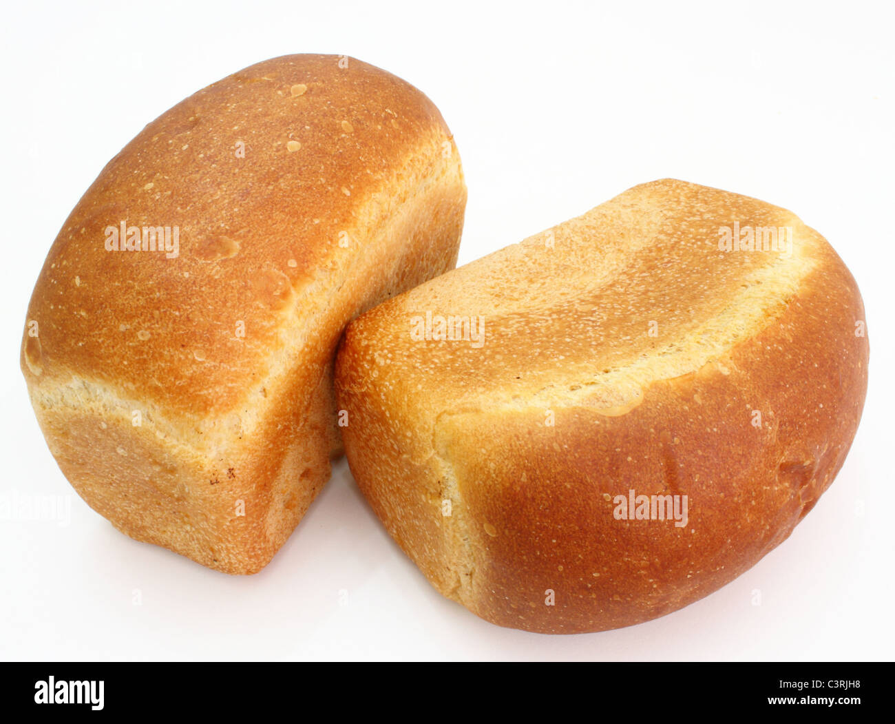 The ruddy long loaf of bread with the fried crust is isolated on a white background Stock Photo