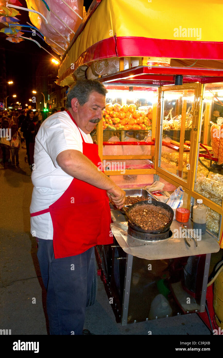 Argentine street vendor making toffee covered nuts at Necochea, Argentina. Stock Photo