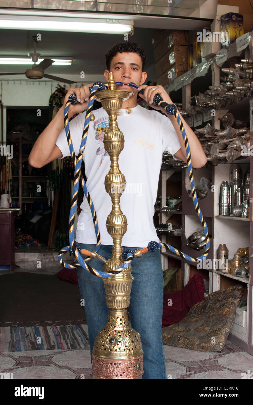 Egyptian young shopkeeper pretending to smoke a shisha pipe Dahab