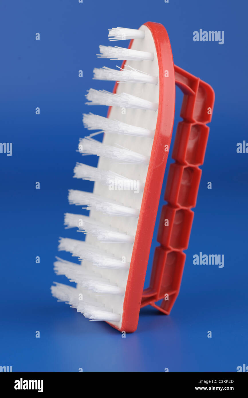 White and red nylon bristle brush in the shape of an iron Stock Photo