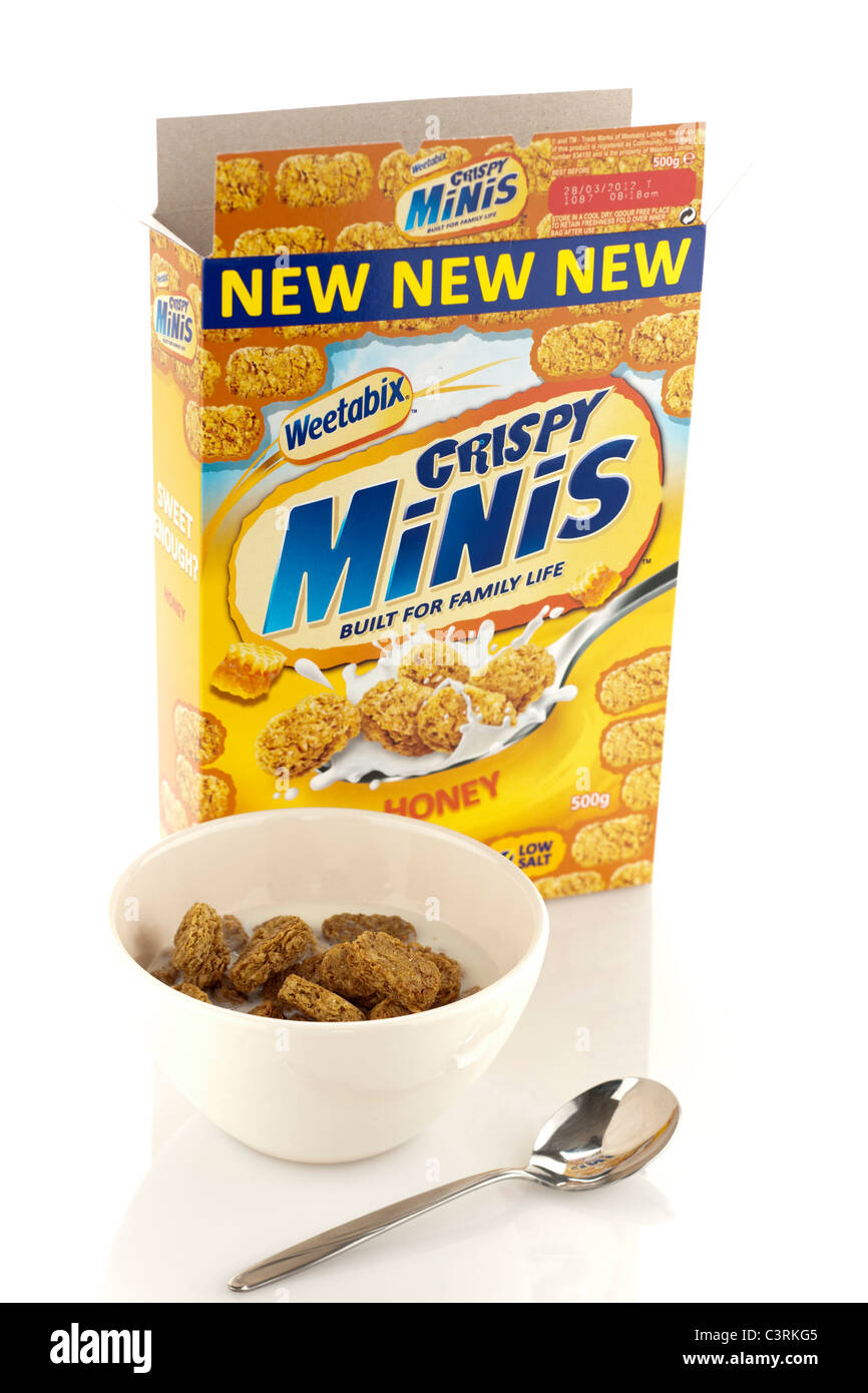 500 gram box of New Weetabix honey crispy minis breakfast cereal bowl milk and spoon Stock Photo
