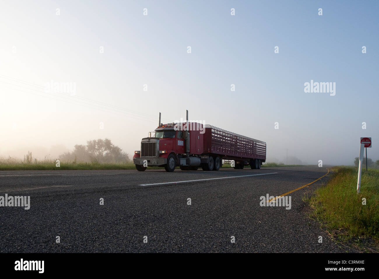 Tractor-trailer travels on US Highway 77 between Raymondville and Kingsville in South Texas USA Stock Photo
