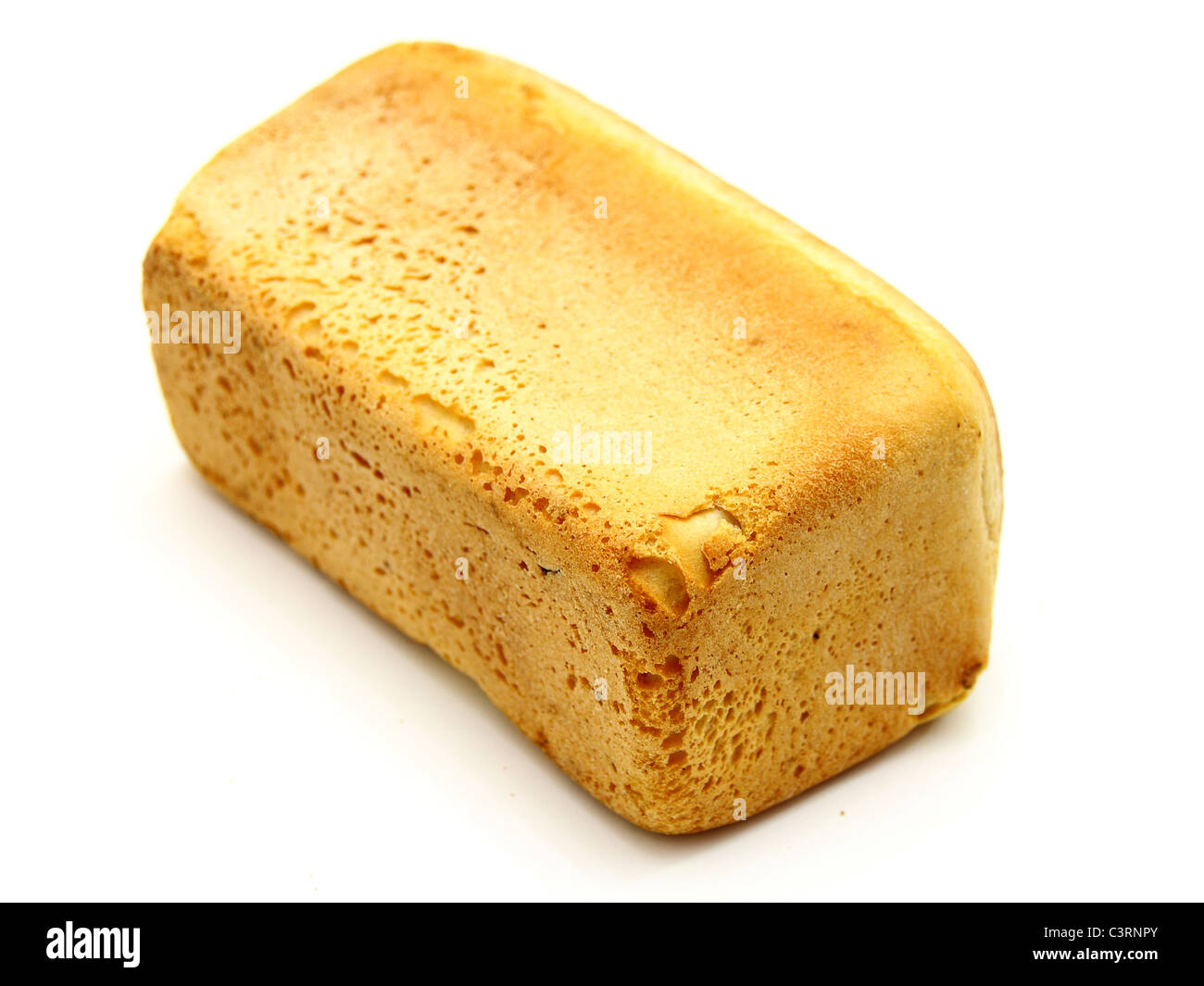 The ruddy long loaf of bread with the fried crust is isolated on a white background Stock Photo
