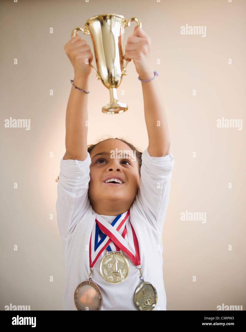 African American girl holding up trophy Stock Photo