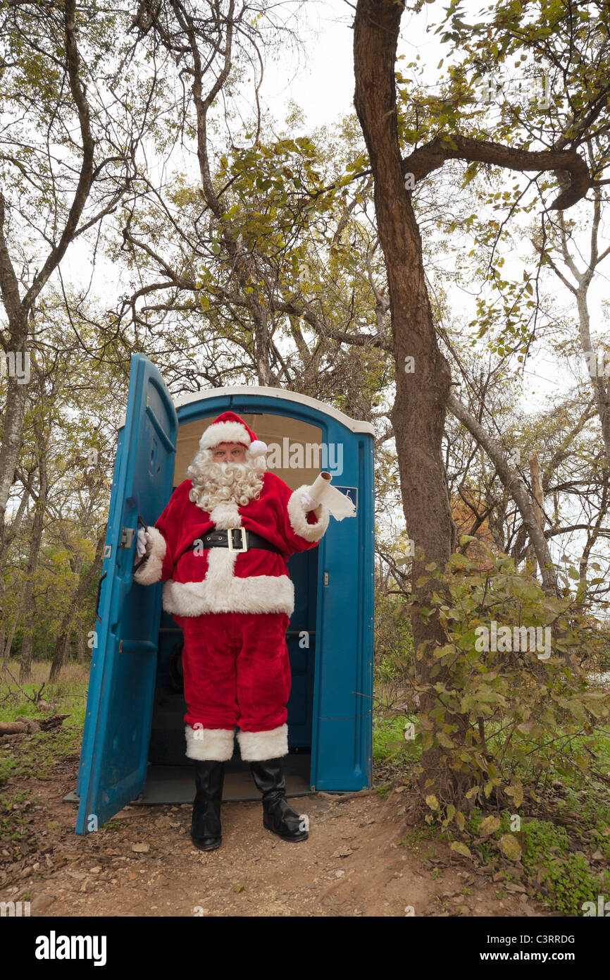 Santa leaving portable toilet Stock Photo