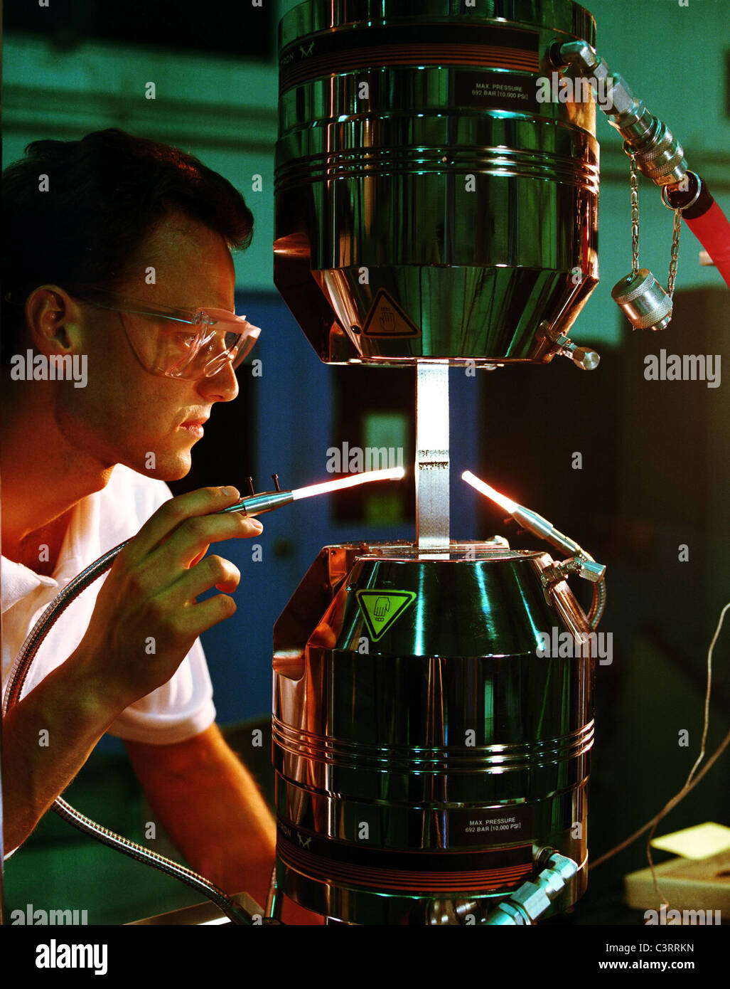 NASA Langley engineer, uses a laser light carried by an optical fiber to  examine a tapered composite specimen on a test stand Stock Photo - Alamy