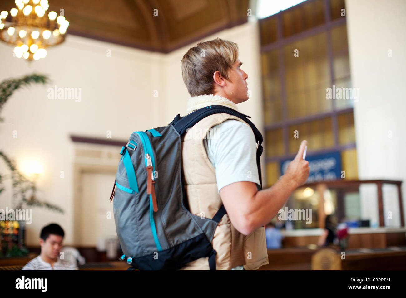 Caucasian man with backpack in train station Stock Photo