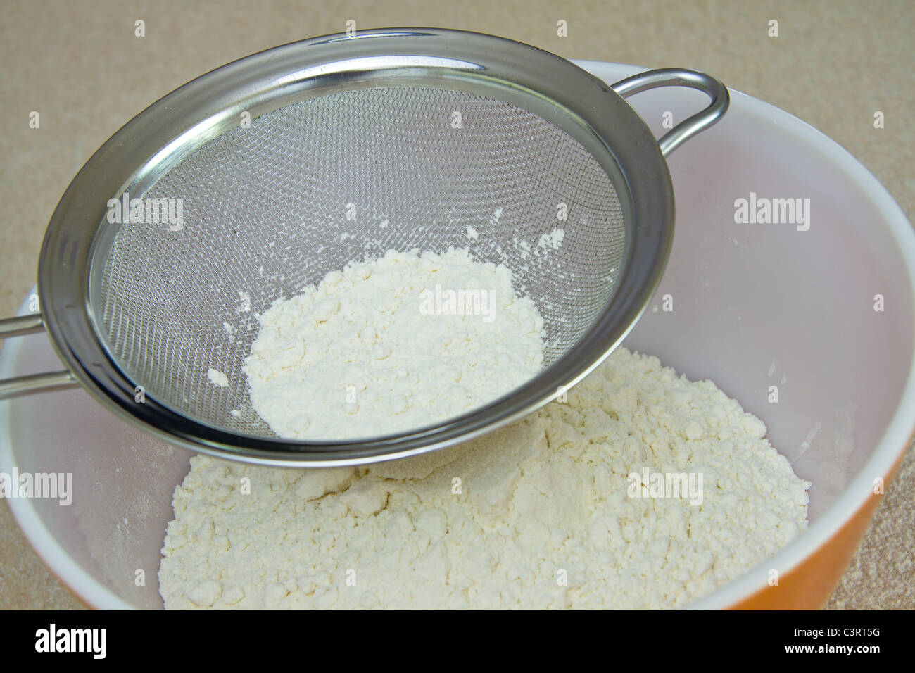 Sifting flour Stock Photo Alamy