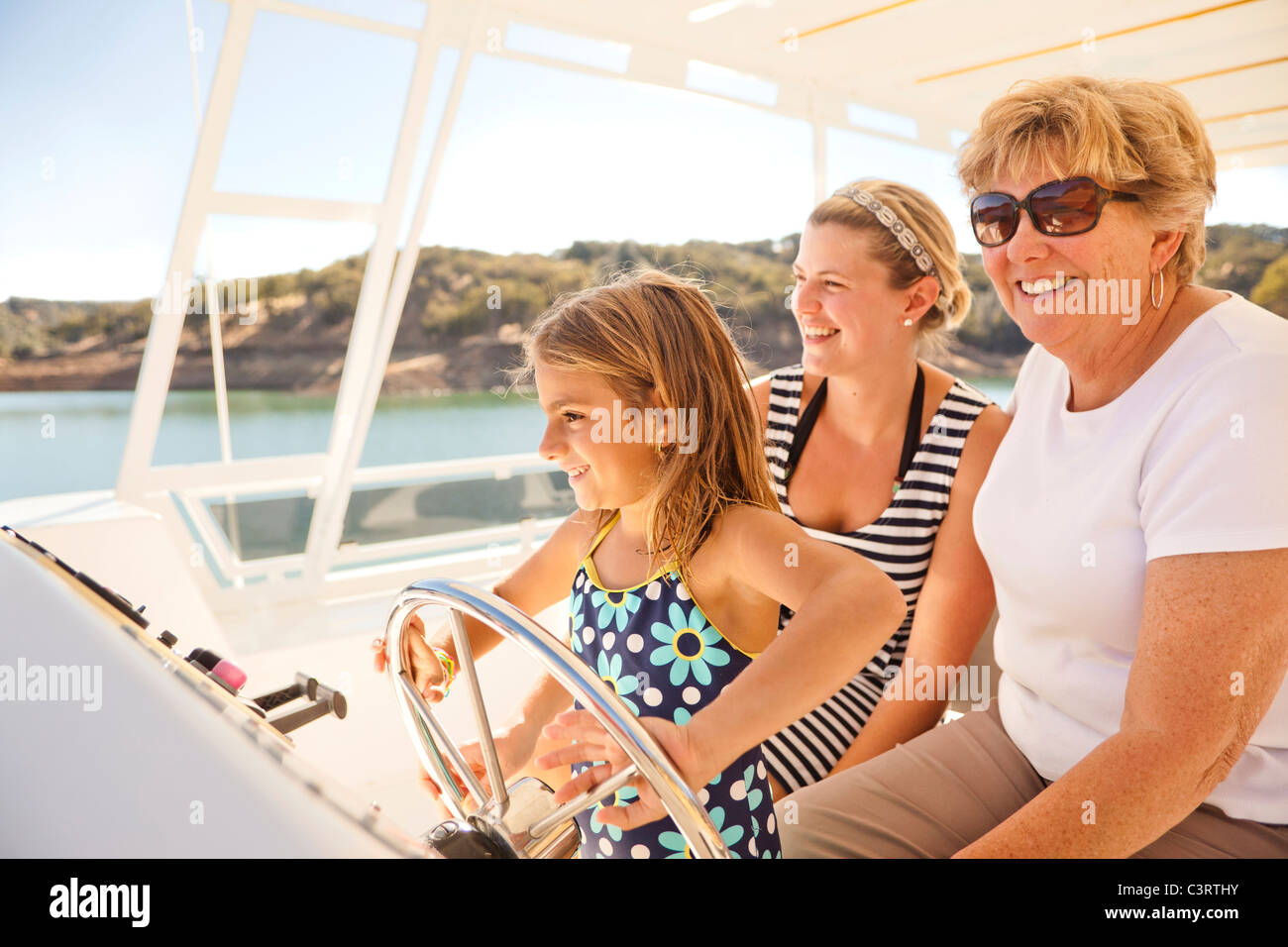 Family enjoying boat on lake Stock Photo Alamy
