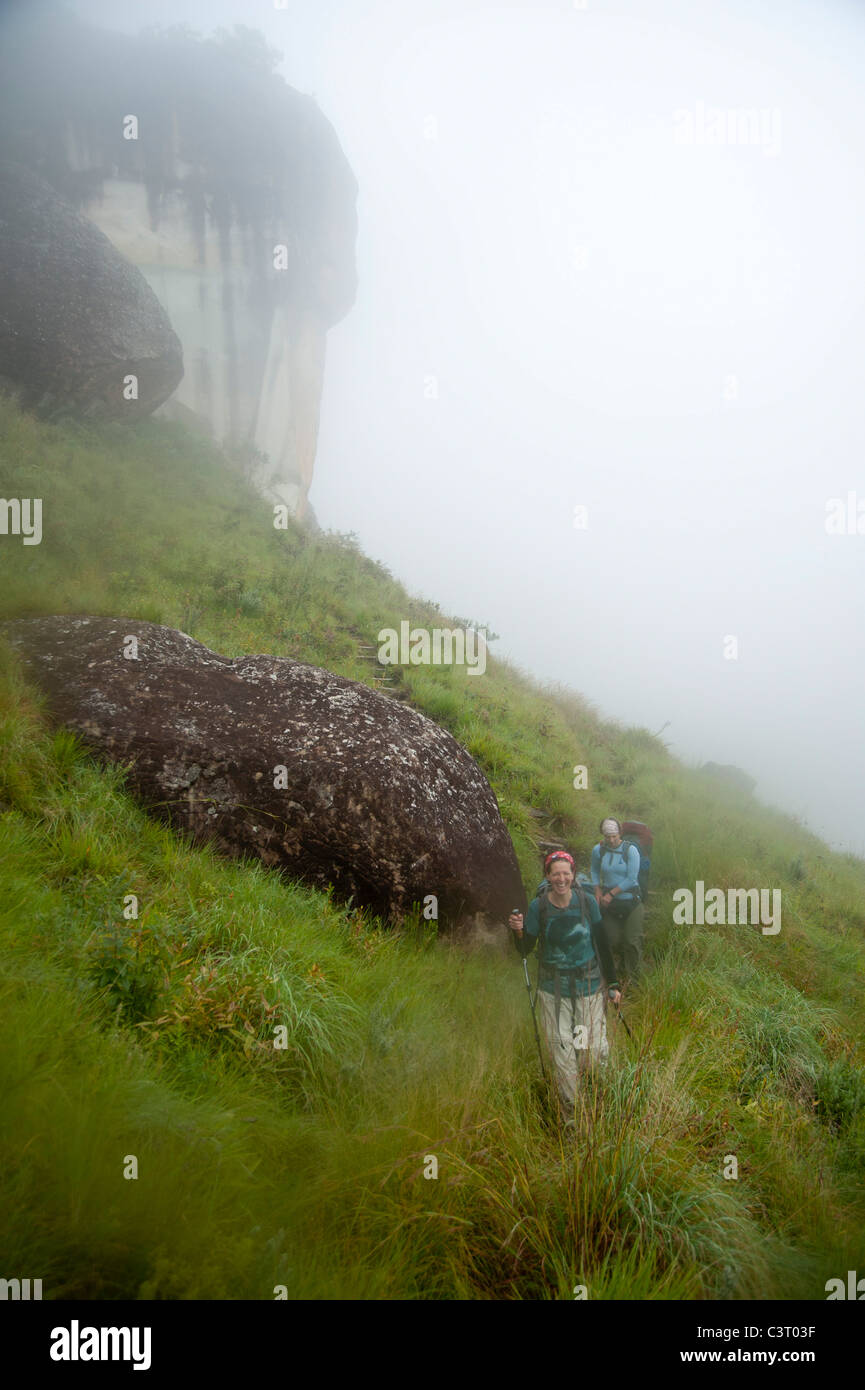 Hikers in the mist, uKhahlamba Drakensberg Park, South Africa Stock Photo