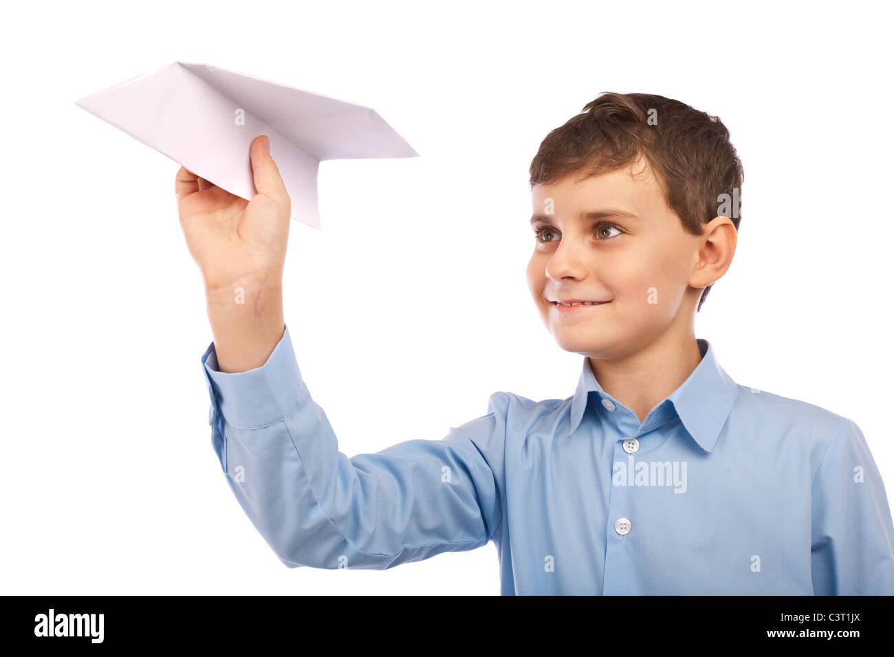 Schoolboy throwing a paper plane, isolated on white background Stock Photo