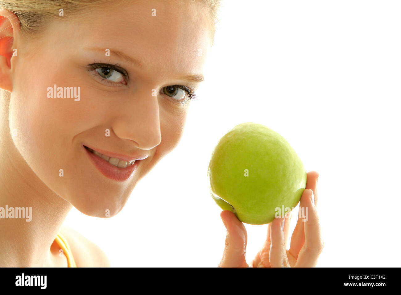 Woman with a fresh green apple Stock Photo