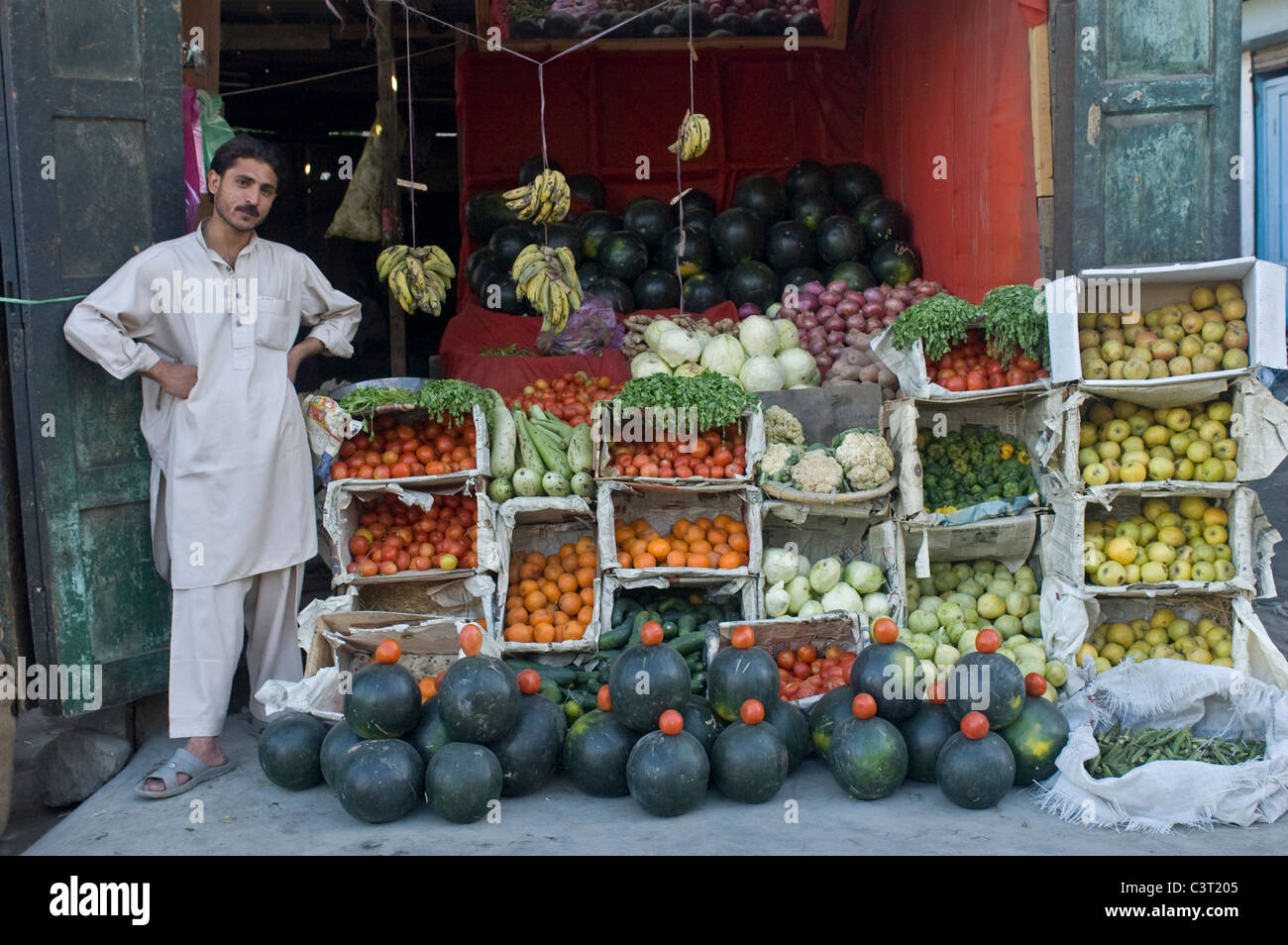 A man selling produce at his shop Stock Photo - Alamy
