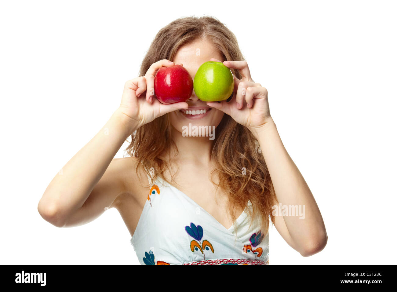 Portrait of a girl covering her eyes with apples Stock Photo