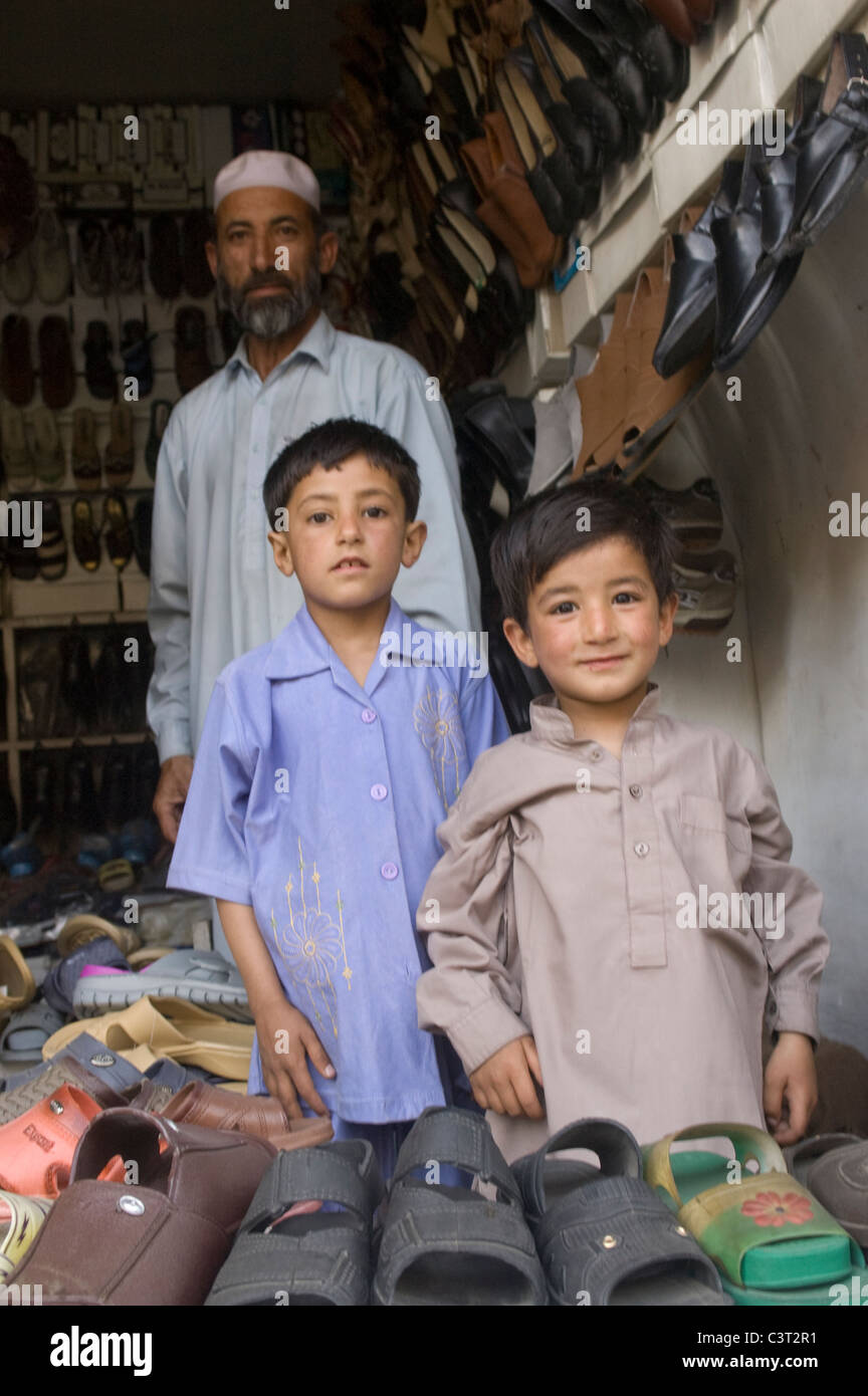 A man and boys at a shoe store. Stock Photo