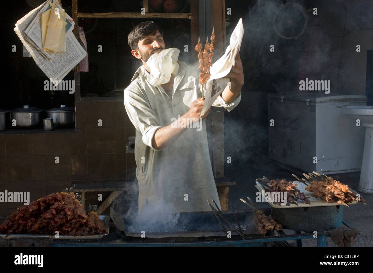 A man prepares food at a shop. Stock Photo