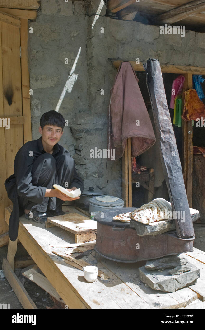 A boy making bread on the Karakoram Highway. Stock Photo