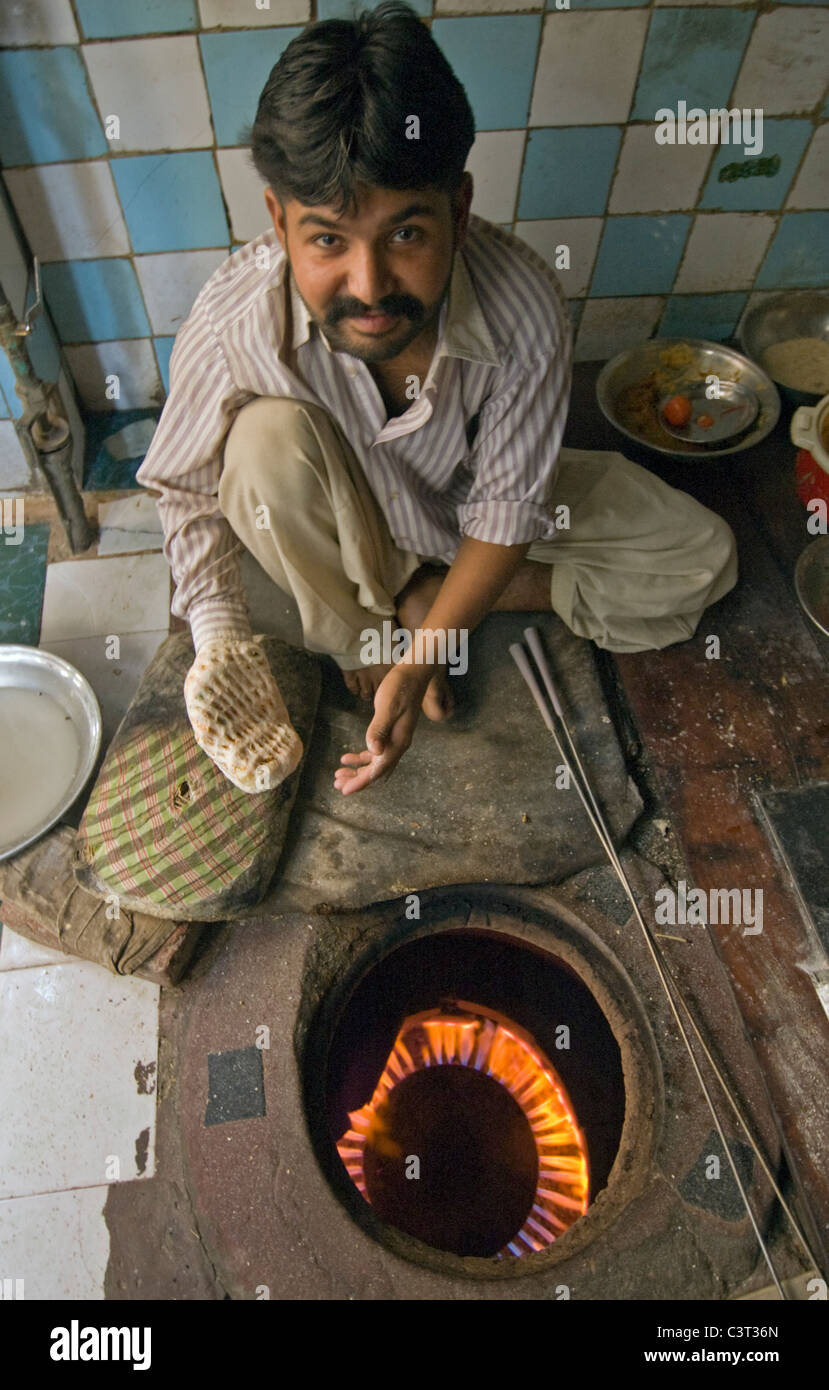 A man puts bread in the oven in the Old City. Stock Photo
