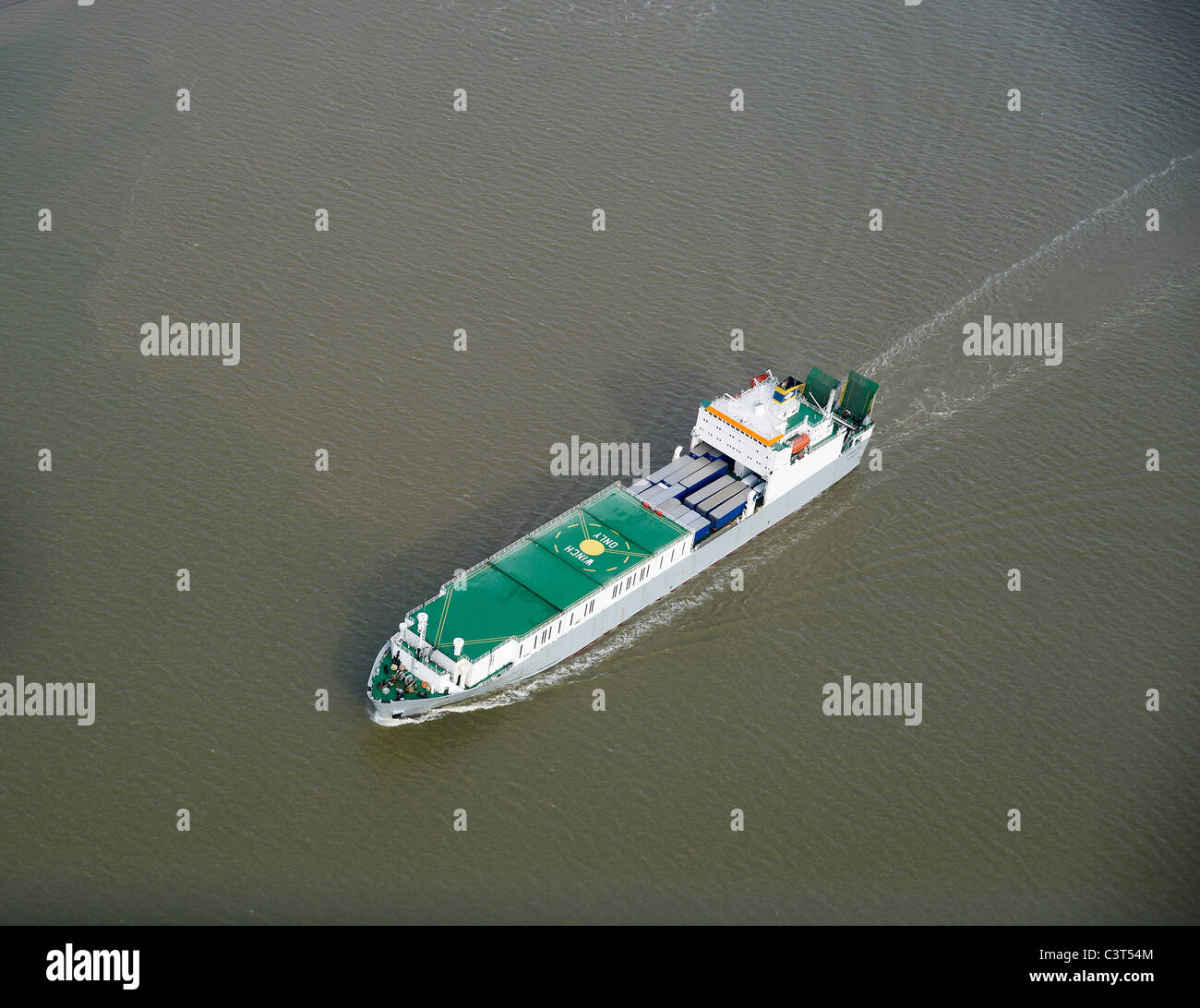 Ship sailing up river on the Thames Estuary, near Tilbury, South East England Stock Photo