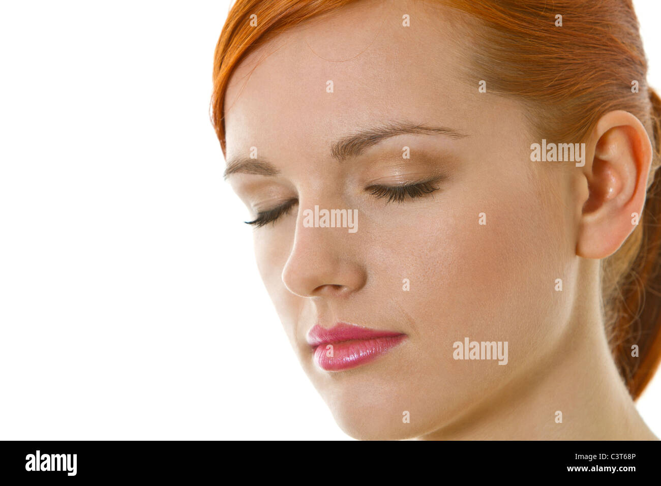 Serious, thoughtful young woman with closed eyes Stock Photo