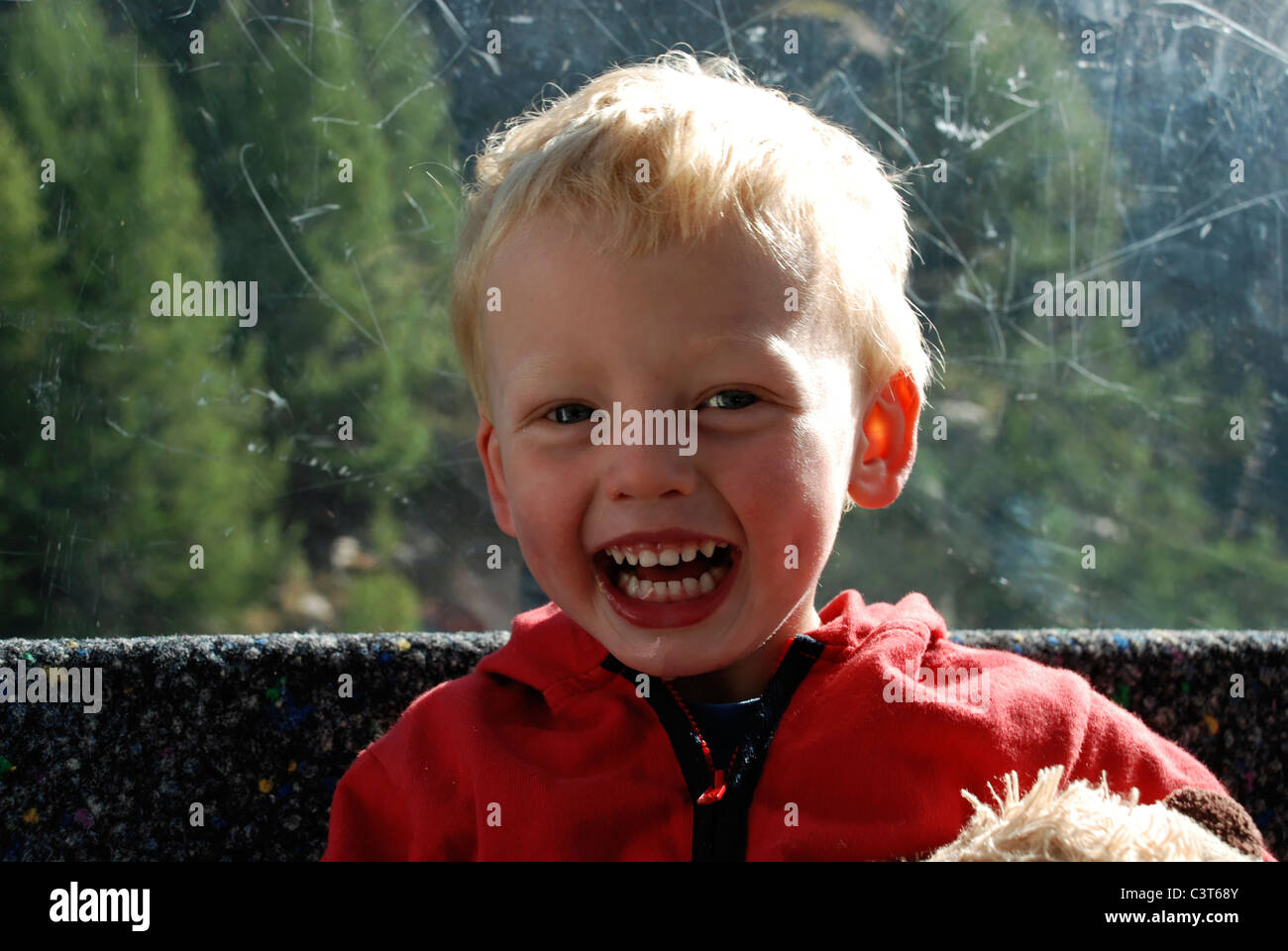 A happy young boy sat in a cable car above Saas Grund, Switzerland. Stock Photo