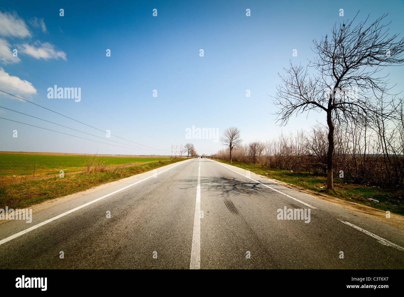 Landscape with empty road under blue sky with clouds Stock Photo - Alamy