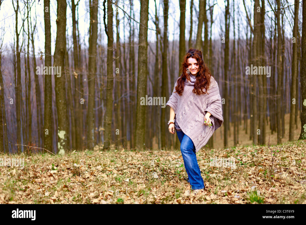 Young woman taking a walk in a beech forest Stock Photo - Alamy